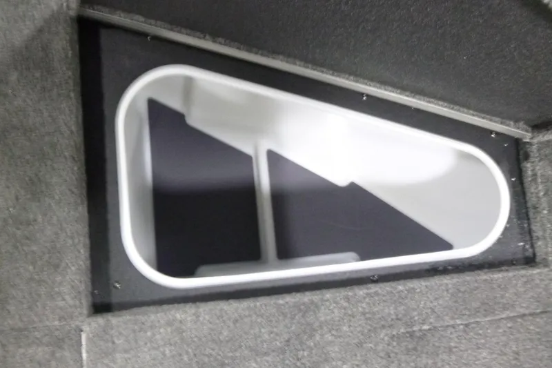 Slide: The Image of 2026 Alumacraft Trophy 205X Sport storage compartment with white interior and gray carpeted exterior. - 6
