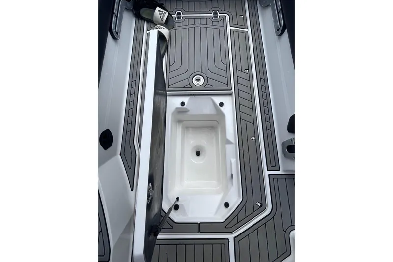 Slide: The Image of 2017 Nautique Super Air Nautique G25 interior with open storage compartment. - 14