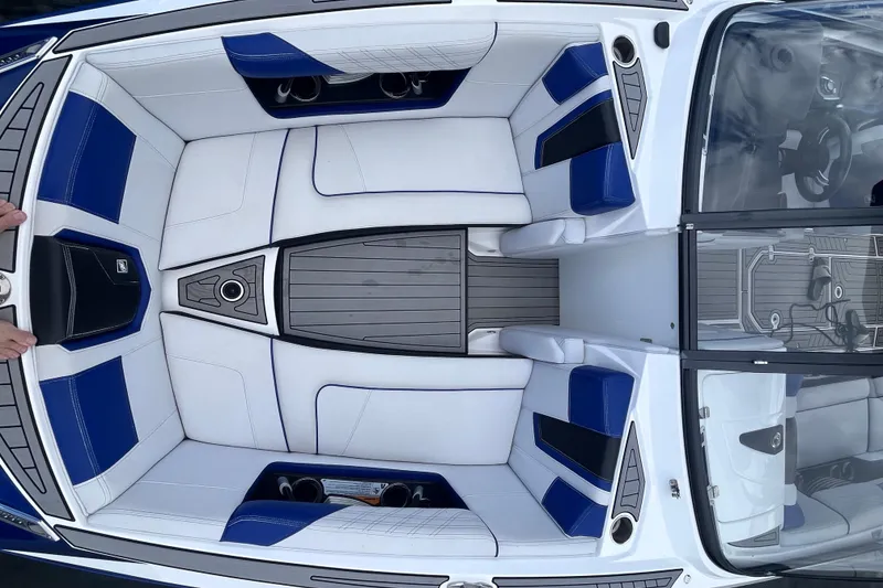 Slide: The Image of 2017 Nautique Super Air Nautique G25 interior with blue and white seating. - 17