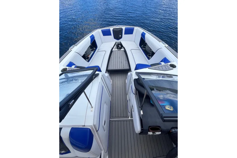 Slide: The Image of 2017 Nautique Super Air Nautique G25 boat interior with blue and white seating. - 18