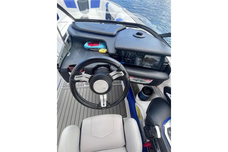 Slide: The Image of 2017 Nautique Super Air Nautique G25 dashboard with steering wheel and digital display. - 19