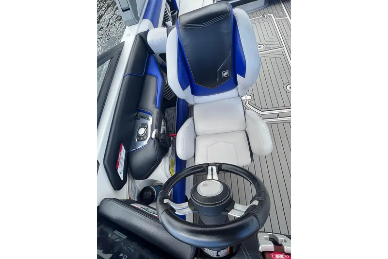 Slide: The Image of 2017 Nautique Super Air Nautique G25 cockpit with steering wheel and captain's chair. - 20