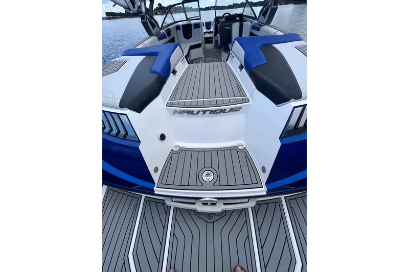 Slide: The Image of 2017 Nautique Super Air Nautique G25 boat interior with blue and gray seating. - 30