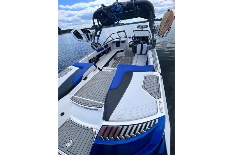 Slide: The Image of 2017 Nautique Super Air Nautique G25 boat interior with blue accents on a calm lake. - 31
