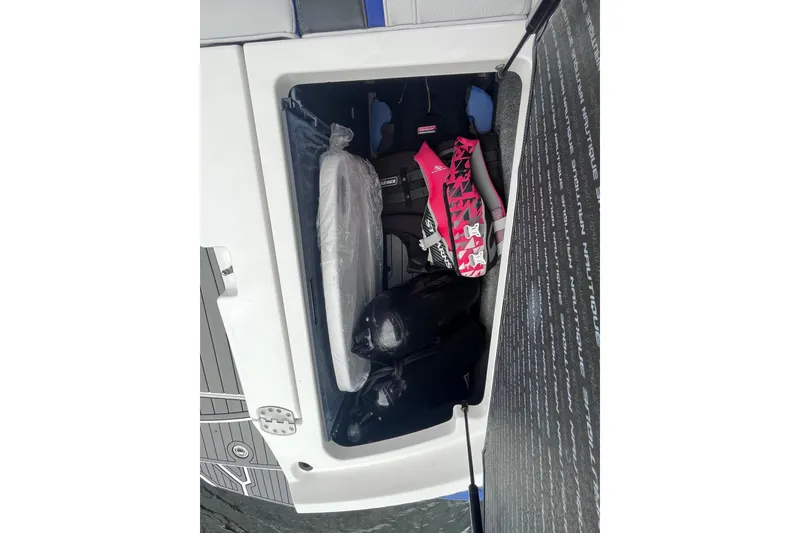 Slide: The Image of 2017 Nautique Super Air Nautique G25 storage compartment with gear and accessories. - 34