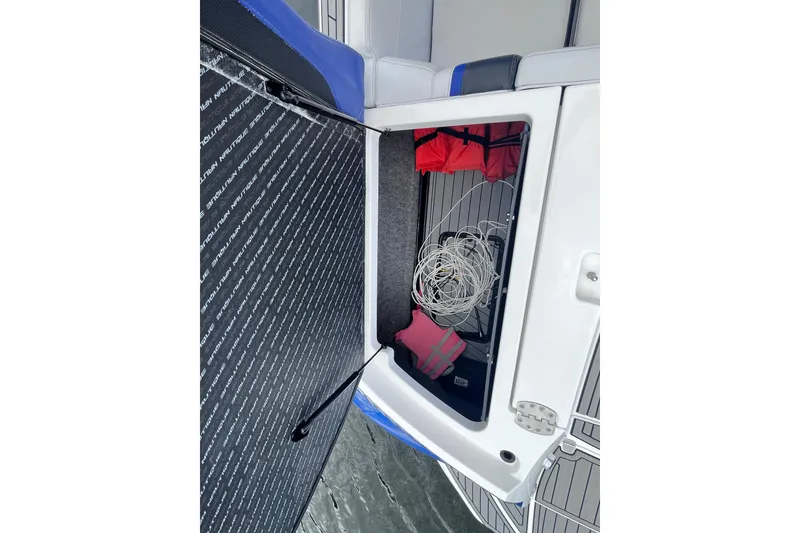Slide: The Image of 2017 Nautique Super Air Nautique G25 storage compartment with life jackets and rope. - 35