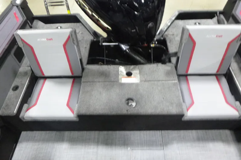 Slide: The Image of 2025 Alumacraft Trophy 205X Sport boat interior with gray and red seating. - 13
