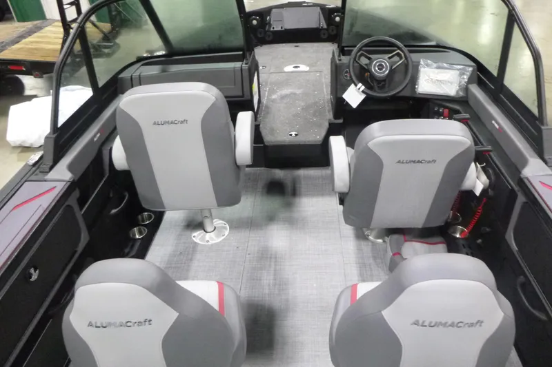 Slide: The Image of 2025 Alumacraft Trophy 205X Sport boat interior with gray seating and modern dashboard. - 4