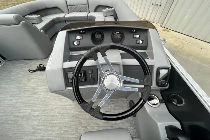 Slide: The Image of 2023 Bennington L 23 Swingback boat dashboard with steering wheel and controls. - 5