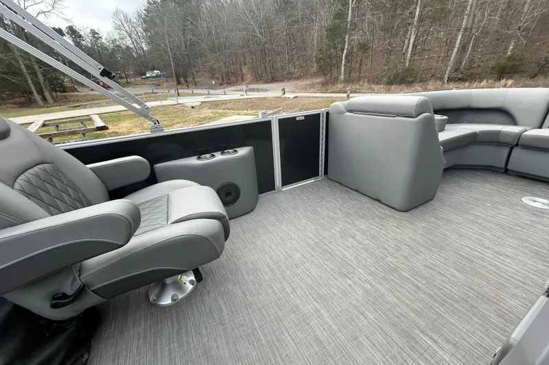 Slide: The Image of 2023 Bennington L 23 Swingback pontoon boat interior with gray seating and flooring. - 9