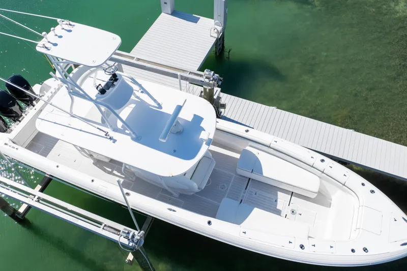 Slide: The Image of 2015 Intrepid 400 Center Console boat docked on clear green water. - 18
