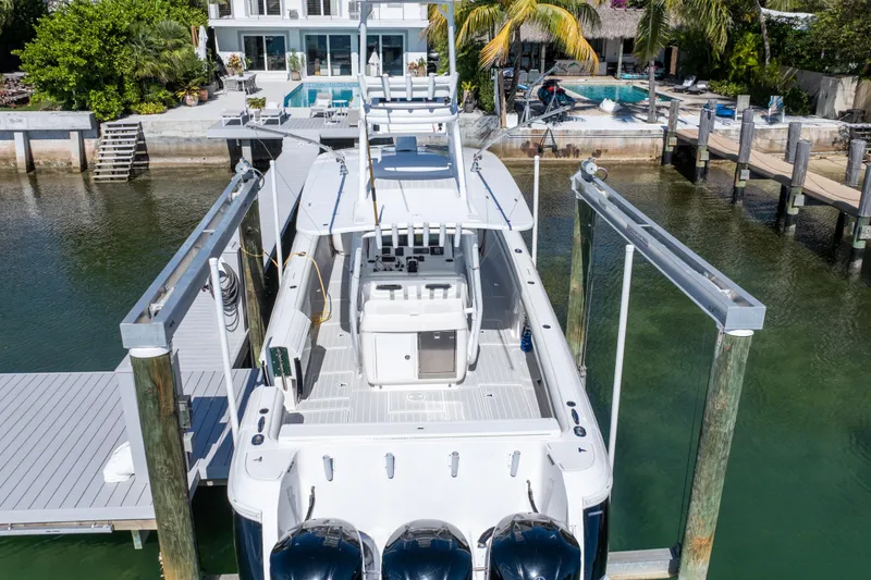 Slide: The Image of 2015 Intrepid 400 Center Console boat docked near waterfront home. - 21
