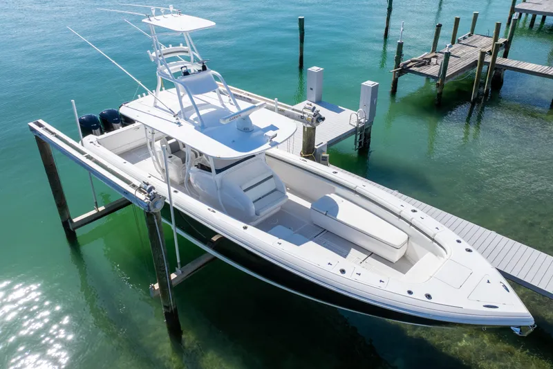 Slide: The Image of 2015 Intrepid 400 Center Console boat docked in clear turquoise water. - 25