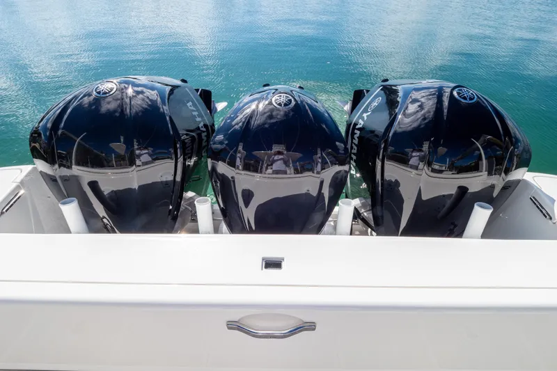 Slide: The Image of 2015 Intrepid 400 Center Console with triple Yamaha outboard engines on water. - 28