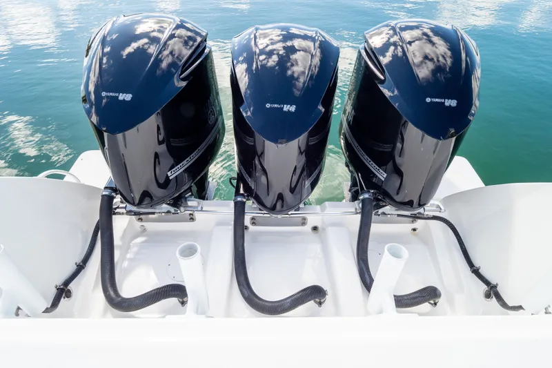 Slide: The Image of Triple Yamaha outboard engines on a 2015 Intrepid 400 Center Console boat. - 30