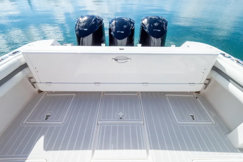 Slide: The Image of 2015 Intrepid 400 Center Console boat with triple outboard engines on calm water. - 34