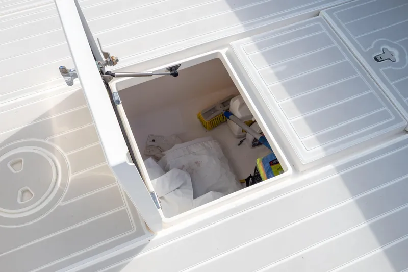 Slide: The Image of Open storage compartment on 2015 Intrepid 400 Center Console boat deck. - 38