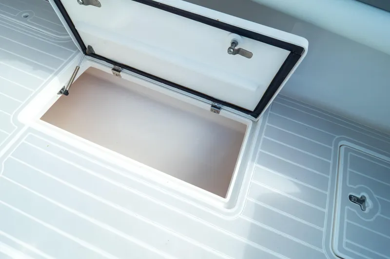 Slide: The Image of Open storage compartment on 2015 Intrepid 400 Center Console boat deck. - 39