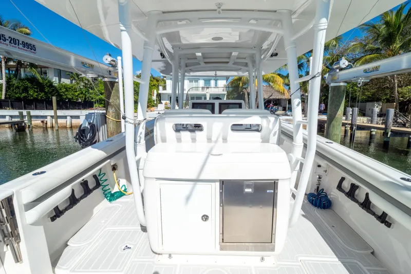 Slide: The Image of 2015 Intrepid 400 Center Console boat docked, featuring spacious deck and modern amenities. - 45
