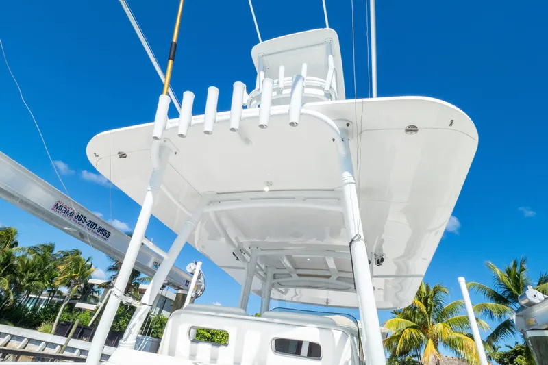 Slide: The Image of 2015 Intrepid 400 Center Console boat with T-top against clear blue sky. - 47