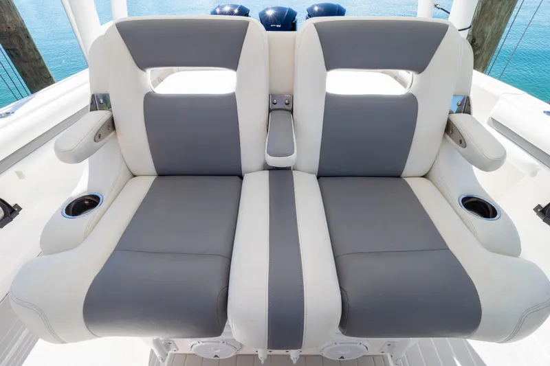 Slide: The Image of 2015 Intrepid 400 Center Console boat seats with cup holders, featuring gray and white upholstery. - 60