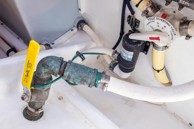 Slide: The Image of Plumbing system of 2015 Intrepid 400 Center Console boat with valves and hoses. - 63