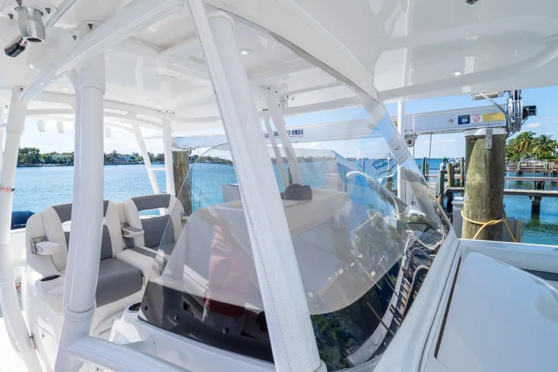Slide: The Image of 2015 Intrepid 400 Center Console boat docked by the water. - 64