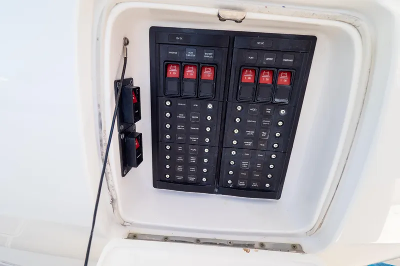 Slide: The Image of Electrical panel on a 2015 Intrepid 400 Center Console boat, featuring switches and circuit breakers. - 69