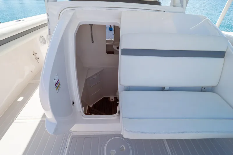 Slide: The Image of 2015 Intrepid 400 Center Console boat interior with open hatch and seating. - 87