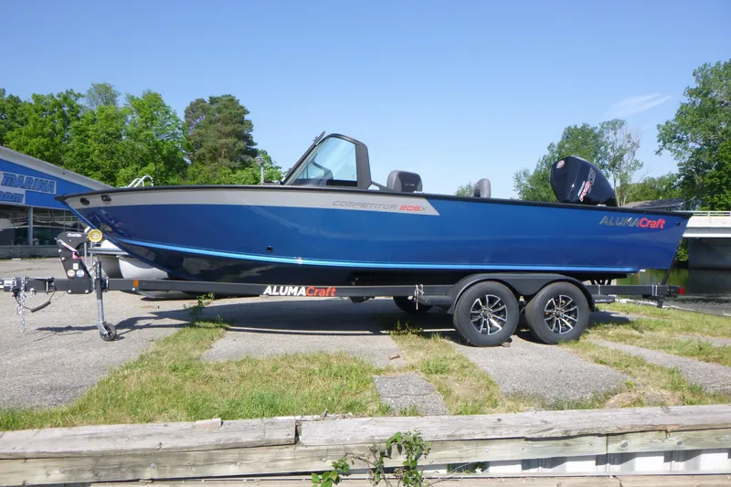 The Image of 2026 Alumacraft Competitor 205 Sport boat on trailer, parked outdoors. - 0