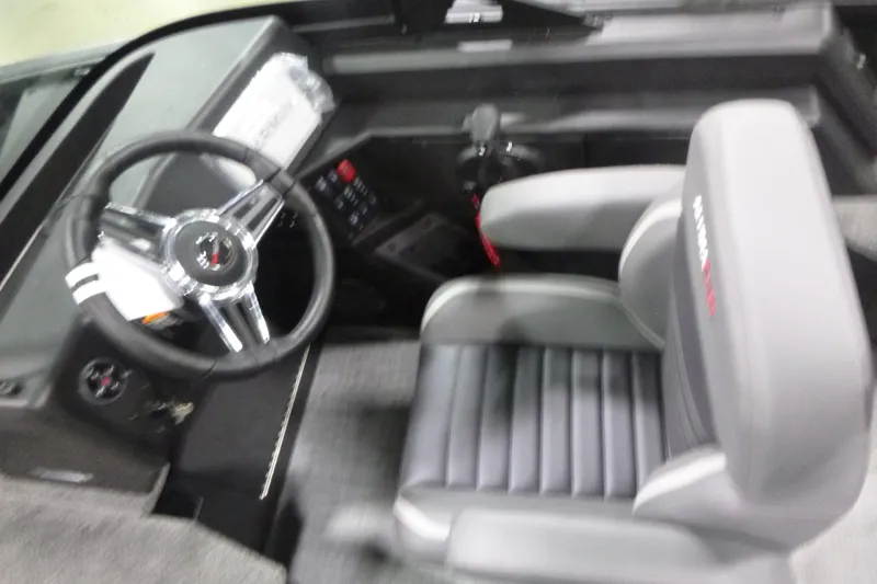 Slide: The Image of 2026 Alumacraft Competitor 205 Sport boat interior with steering wheel and seat. - 12