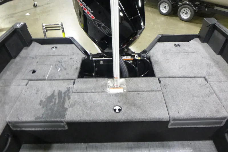 Slide: The Image of 2026 Alumacraft Competitor 205 Sport boat interior with motor and carpeted deck. - 16