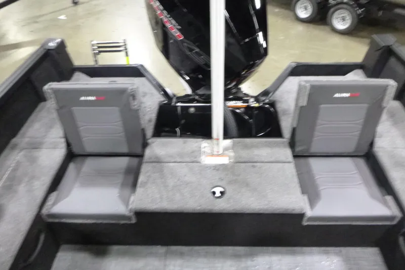 Slide: The Image of 2026 Alumacraft Competitor 205 Sport boat interior with gray seating and motor. - 17