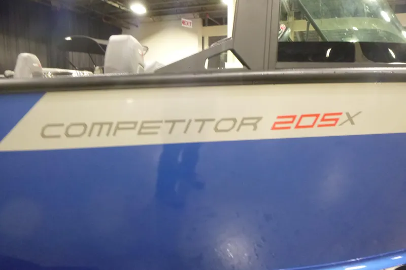 Slide: The Image of 2026 Alumacraft Competitor 205 Sport boat, blue exterior with model name visible. - 20