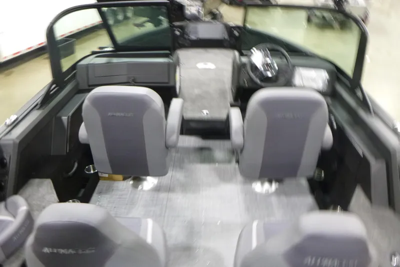 Slide: The Image of 2026 Alumacraft Competitor 205 Sport interior with seating and steering console. - 5