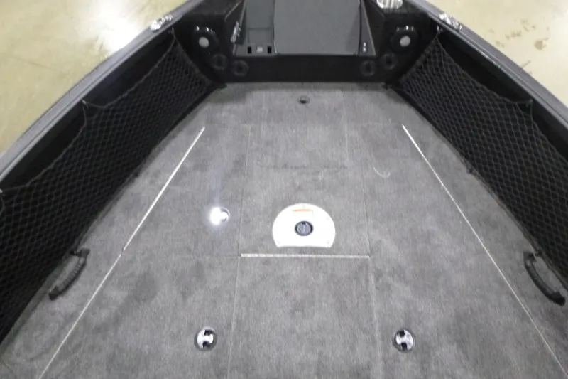 Slide: The Image of 2026 Alumacraft Competitor 205 Sport boat interior with carpeted deck and storage compartments. - 7