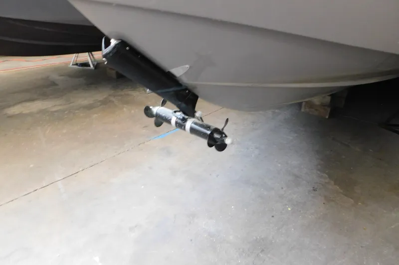 Slide: The Image of 2017 Rinker EX 320 boat propeller and hull in a garage setting. - 10