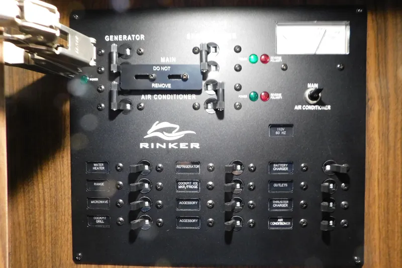 Slide: The Image of Electrical control panel of a 2017 Rinker EX 320 boat, featuring various switches and indicators. - 104