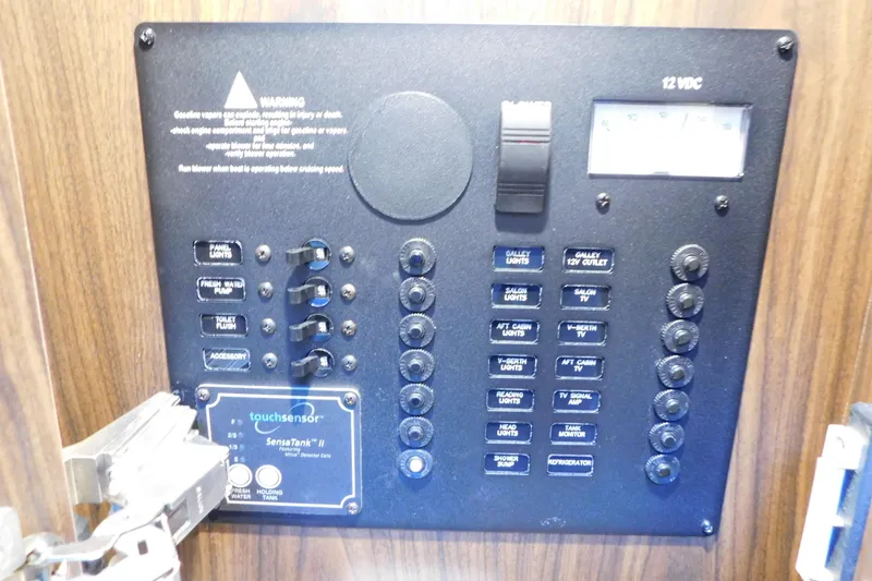 Slide: The Image of Control panel of a 2017 Rinker EX 320 boat with various switches and indicators. - 105