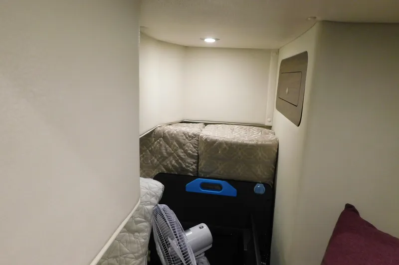 Slide: The Image of 2017 Rinker EX 320 cabin interior with cushions and a fan. - 107