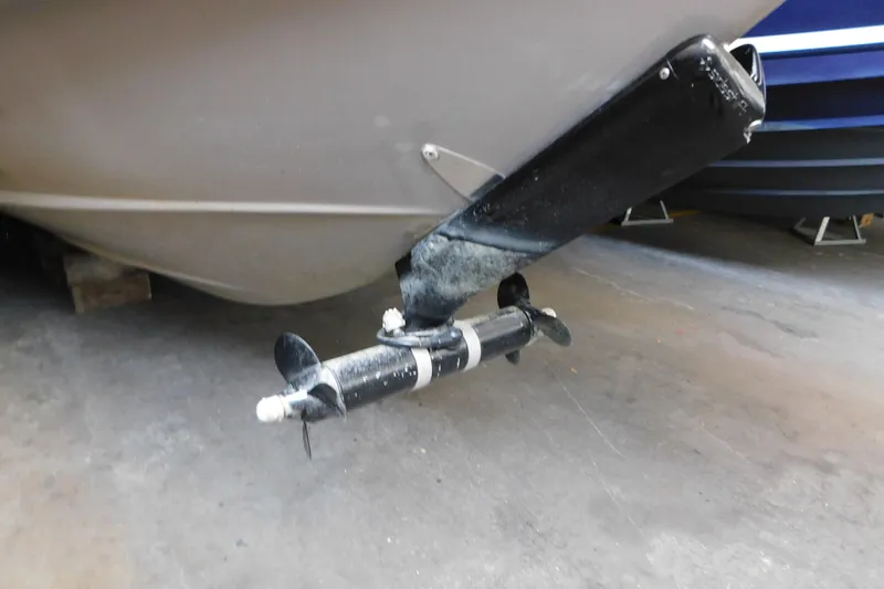 Slide: The Image of 2017 Rinker EX 320 boat propeller and hull in a garage setting. - 11