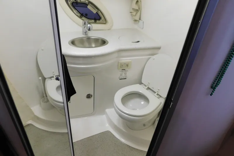 Slide: The Image of 2017 Rinker EX 320 boat bathroom with sink and toilet. - 113