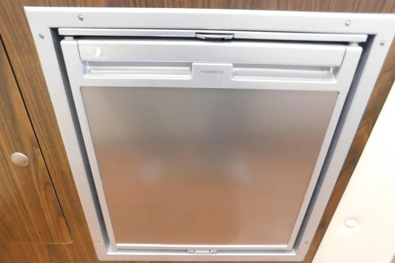 Slide: The Image of Built-in Dometic fridge in 2017 Rinker EX 320 boat interior. - 118