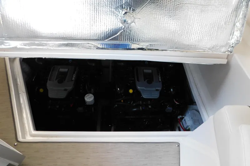 Slide: The Image of Engine compartment of a 2017 Rinker EX 320 boat, showcasing dual engines. - 121