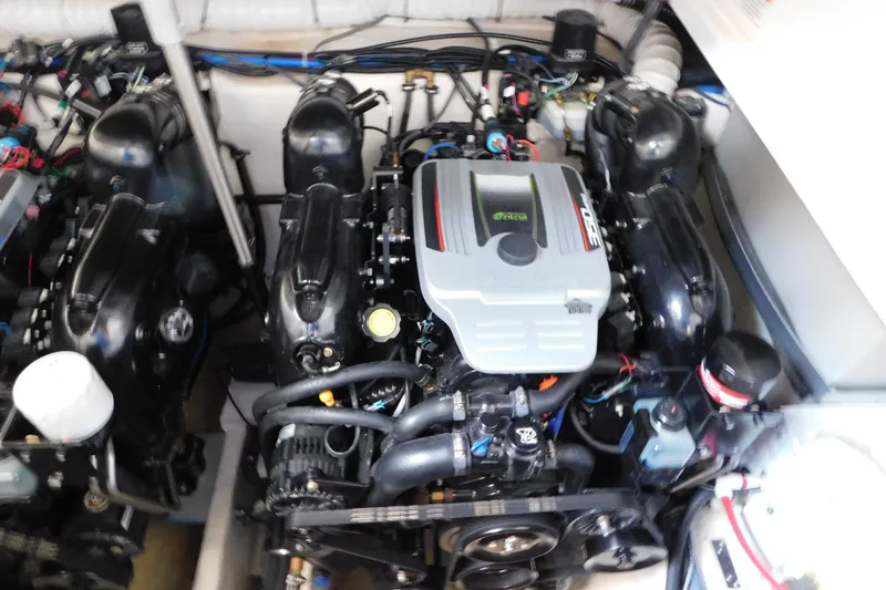 Slide: The Image of Engine compartment of a 2017 Rinker EX 320 boat, showcasing dual engines and components. - 124