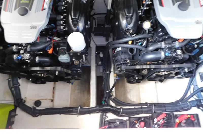 Slide: The Image of Engine compartment of a 2017 Rinker EX 320 boat, showcasing dual engines and components. - 126