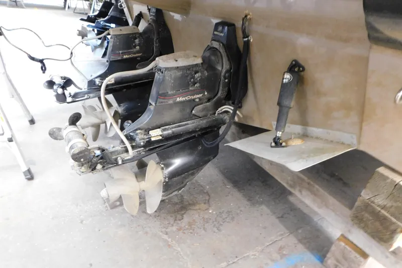 Slide: The Image of 2017 Rinker EX 320 boat with MerCruiser outboard engines in a garage. - 15