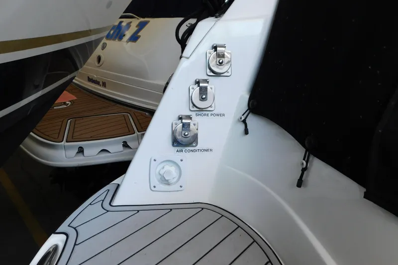 Slide: The Image of 2017 Rinker EX 320 boat with shore power and air conditioner connections. - 17