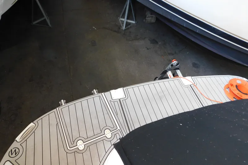 Slide: The Image of 2017 Rinker EX 320 boat deck with orange cable in storage area. - 19