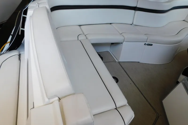 Slide: The Image of 2017 Rinker EX 320 boat interior with white cushioned seating. - 22
